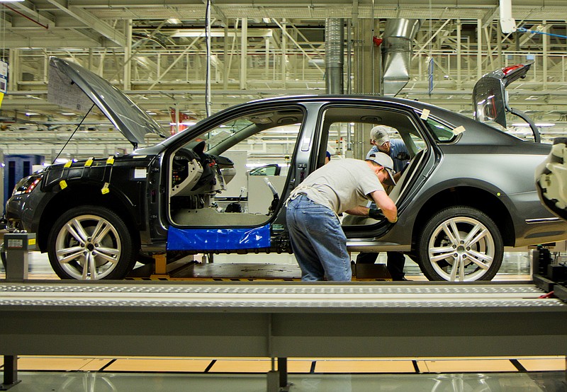 FILE - In this March 22, 2012, file photo, workers assemble a Passat sedan at Volkswagen AG's plant in Chattanooga, Tenn. The German automaker is conducting a national ad campaign to attract skilled workers to fill 1,000 new jobs at the plant this year. (AP Photo/Erik Schelzig, File)