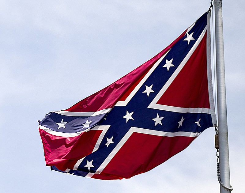 
              FILE - In this June 30, 2015 file photo, a Confederate flag flies at the base of Stone Mountain in Stone Mountain, Ga.  The House is about to put its members on record on whether Confederate flags can decorate rebel graves in historic federal cemeteries and if their sale should be banned in national park gift shops.  The vote comes after southern lawmakers complained that they were sandbagged two nights ago when the House voted — without a recorded tally — to ban the display of Confederate flags at historic federal cemeteries and strengthen Park Service policy against its sale in gift shops.  (AP Photo/David Goldman, File)
            