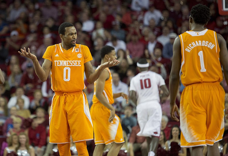 Tennessee guard Kevin Punter, left, reacts to a foul call during the first half of an NCAA college basketball game against Arkansas on Tuesday, Jan. 27, 2015, in Fayetteville, Ark. AP Photo/Gareth Patterson)