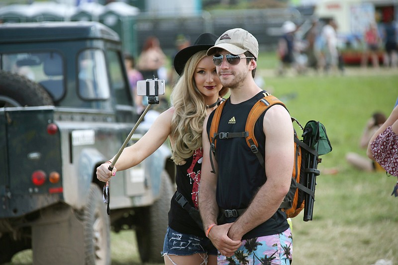 Music fans take a selfie with a stick at the Glastonbury Music Festival on Thursday, June 25, 2015 at Worthy Farm, Glastonbury, England. (Photo by Joel Ryan/Invision/AP)