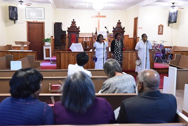 Linda Finley, Sharon Pollard and Veronica Pollard sing during a worship service at Hemphill African Methodist Episcopal Zion Church on Sunday in Summerville, Ga.