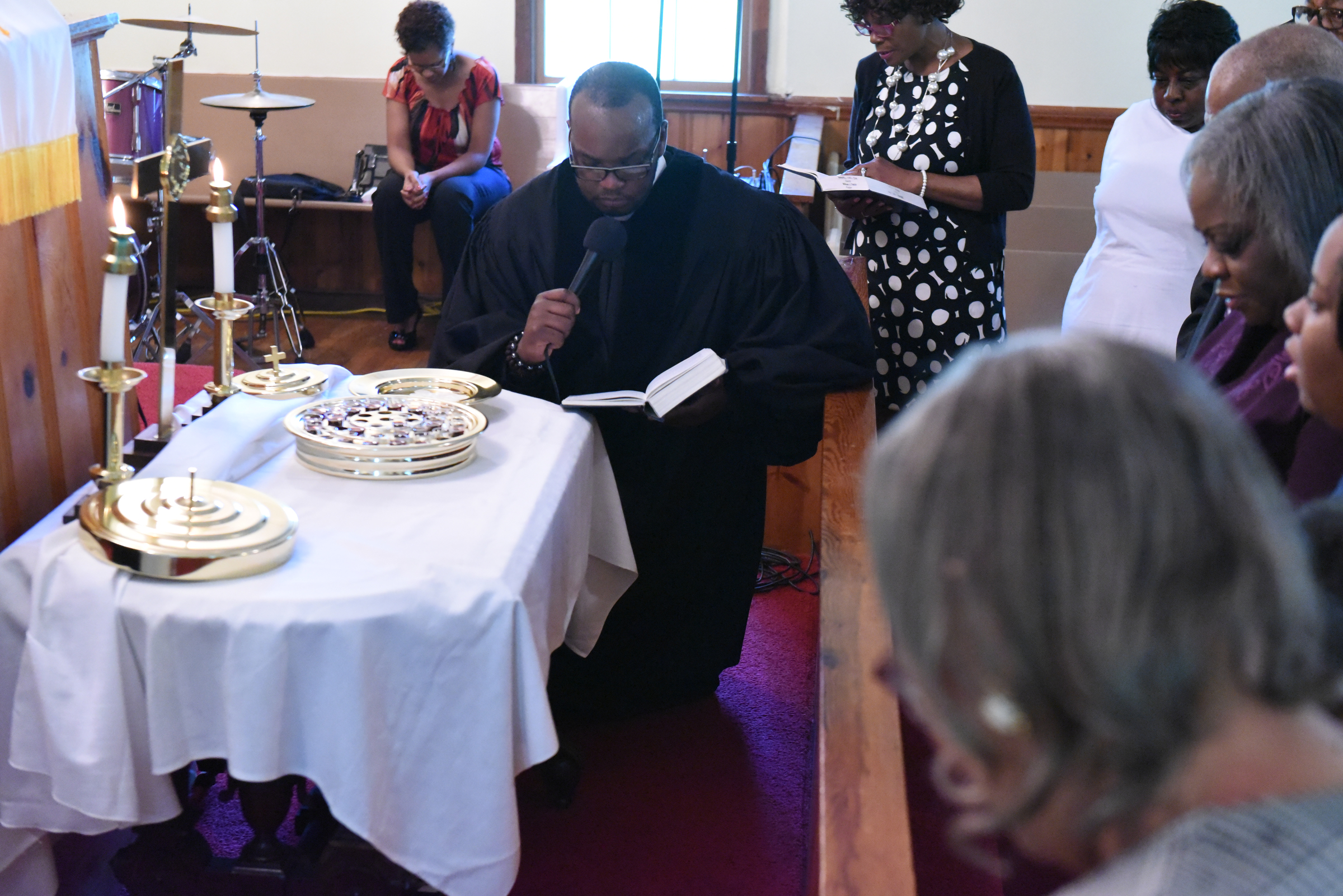 Rev. Solomon Missouri gives communion during a worship service at Hemphill African Methodist Episcopal Zion Church on Sunday in Summerville, Ga.