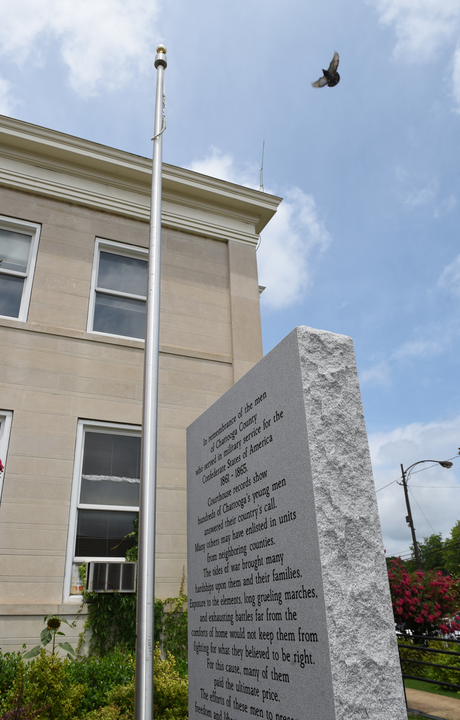 The Confederate flag has been taken down from a flagpole next to a Confederate monument seen on the front lawn of the Chattooga County Courthouse on Sunday in Summerville, Ga.