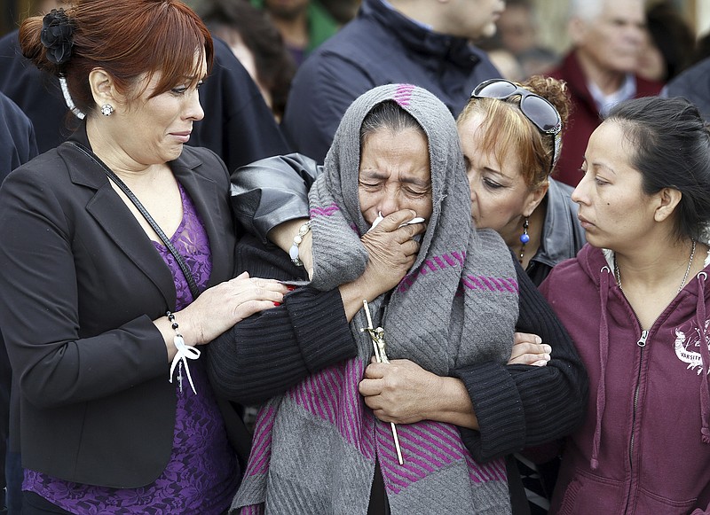 
              FILE -  In this Feb. 25, 2015 file photo, Agapita Montes-Rivera, center, the mother of Antonio Zambrano-Montes, is comforted following the funeral for her son in Pasco, Wash.  A Washington state man was holding a large rock and drew back his arm as if he was going to throw it when police officers opened fire and killed him, one of the officers said in a recording released Wednesday, July 8. (AP Photo/The Tri-City Herald, Andrew Jansen, File)
            