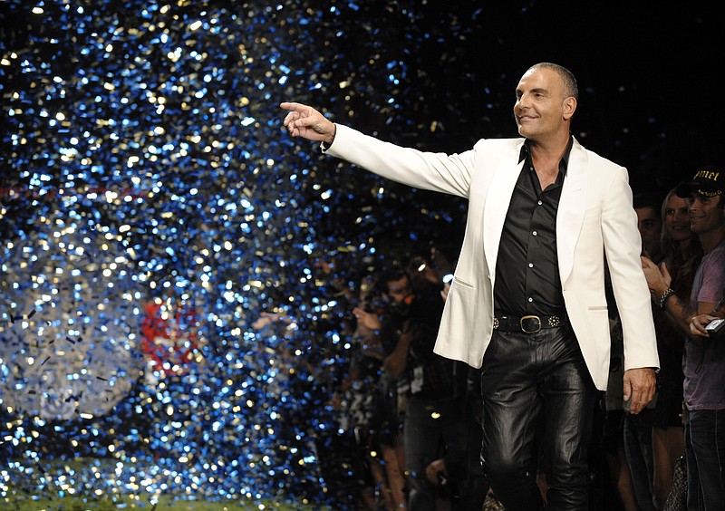 
              FILE - In this Oct. 15, 2008 file photo, designer Christian Audigier gestures to the crowd after his Christian Audigier Presents American Lord show during Mercedes-Benz fashion week in Culver City, Calif. Audigier, who was born in France but gained fame in the United States with his tattoo-inspired, street-wise designs for the Ed Hardy and Von Dutch brands, died Friday, July 10, 2015 of cancer at Cedars-Sinai Medical Center, in Los Angeles. He was 57. (AP Photo/Chris Pizzello, File)
            