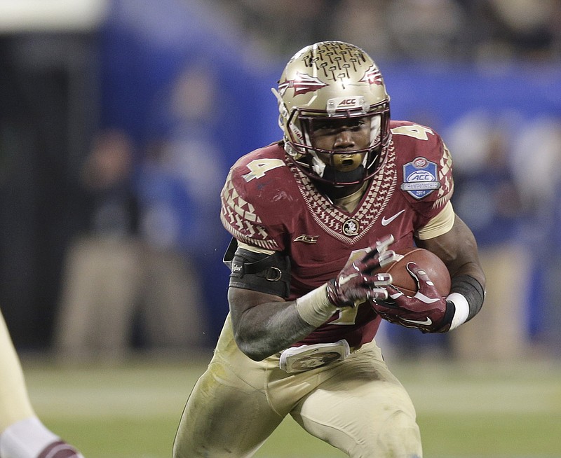 In this Saturday, Dec. 6, 2014, file photo, Florida State's Dalvin Cook (4) runs against Georgia Tech during the second half of the Atlantic Coast Conference championship NCAA college football game in Charlotte, N.C.