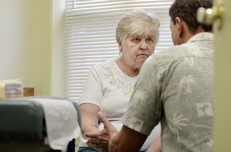 Mary Zebrowski, 75, listens while discussing end of life care with Dr. Joseph Hinterberger in Dundee, N.Y., last year. Medicare is proposing to reimburse doctors for having conversations with patients about end-of-life care.