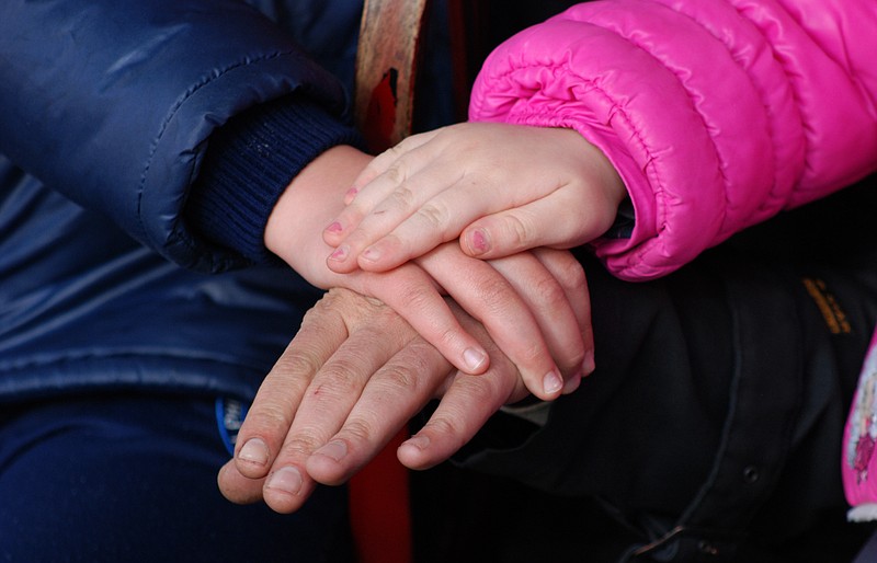 Family holding hands together