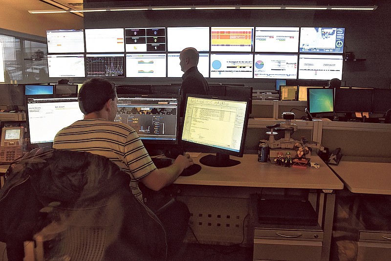 Two men work in the EPB Fiber Optic control room Thursday following an FCC decision that allows gigabit Internet service to expand beyond the Chattanooga area.