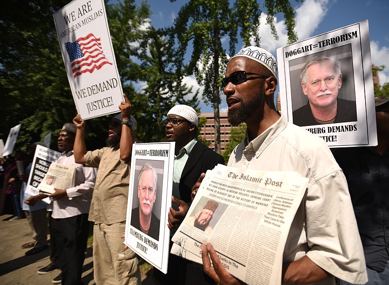 Naaji Abdul Alim, right, and other Muslims rally near the Joel W. Solomon Federal building Monday, July 13, 2015 to protest what they see as light treatment of Robert Doggart, who plotted to murder Muslims in Islamberg, N.Y. 