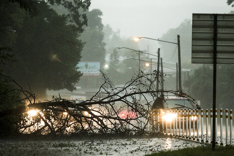 A downed tree blocks the on-ramp to U.S. Highway 27 Southbound from Dayton Boulevard as heavy thunderstorms sweep through the region Tuesday, July 14, 2015, in Red Bank, Tenn.