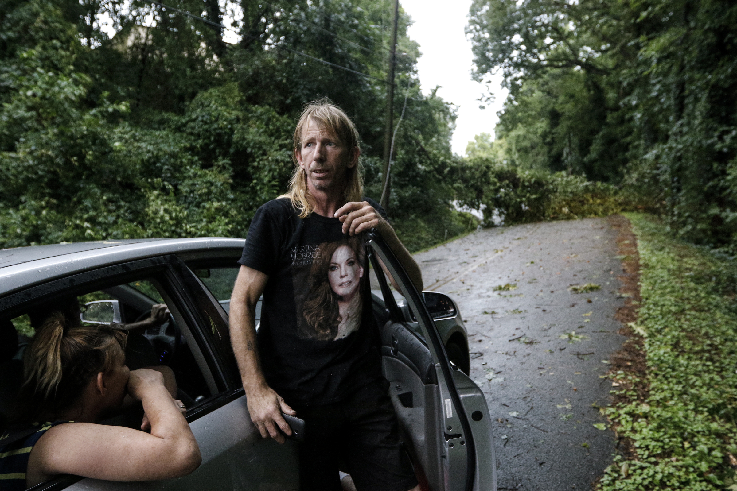 Zeke McGlamery steps out of his car after reaching a downed tree blocking access to Hedgewood Drive after heavy thunderstorms swept through the region Tuesday, July 14, 2015, in Red Bank, Tenn.