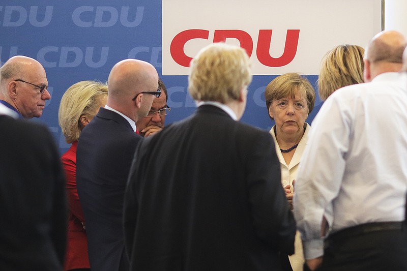 
              German Chancellor Angela Merkel, third right, attends a leaders meeting of her Christian Democratic Union party, CDU, at the party's headquarters in Berlin, Germany, Monday, July 13, 2015. A summit of eurozone leaders reached a tentative agreement with Greece on Monday for a bailout program that includes "serious reforms" and aid, removing an immediate threat that Greece could collapse financially and leave the euro. (AP Photo/Markus Schreiber)
            