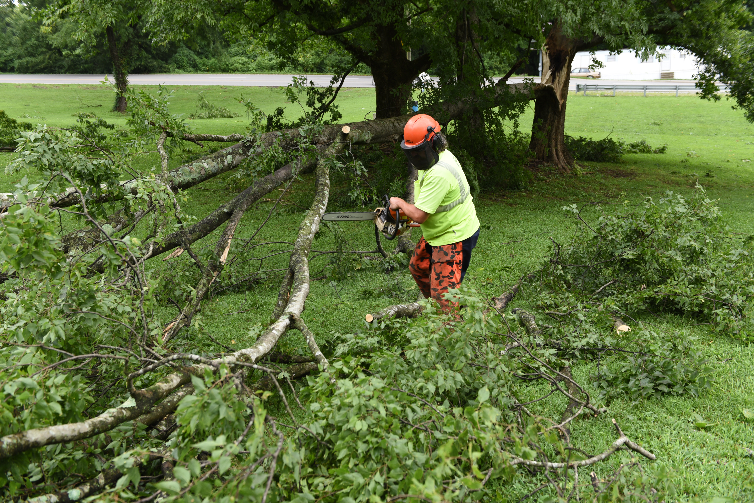City of Chattanooga employee Brad Moulder cleans up storm damage at Portland Park at the foot of Signal Mountain on Wednesday, July 15, 2015, in Chattanooga, Tenn. A strong line of Tuesday evening thunderstorms caused storm damage in various parts of the Chattanooga area.
