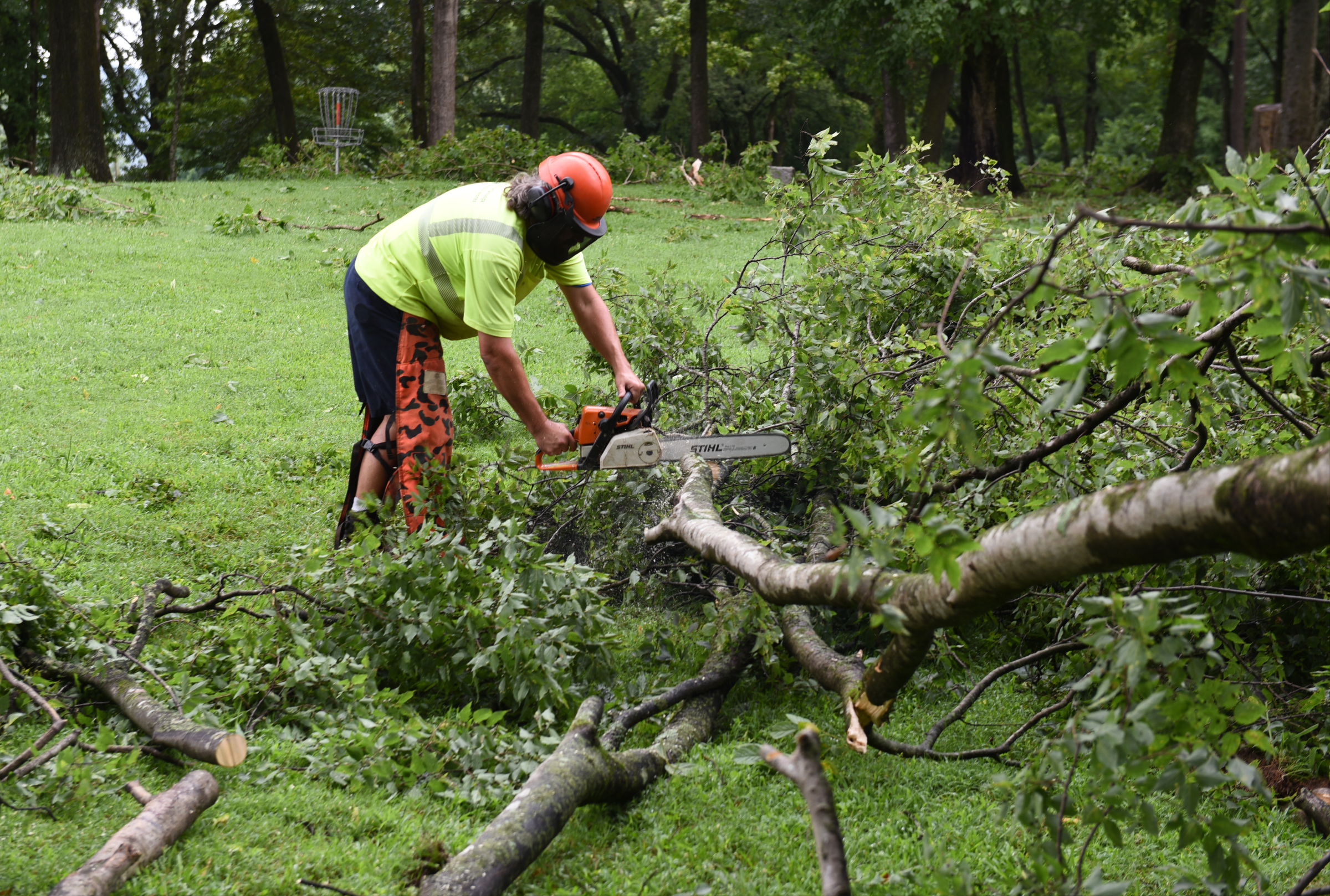 City of Chattanooga employee Brad Moulder cleans up storm damage at Portland Park at the foot of Signal Mountain on Wednesday, July 15, 2015, in Chattanooga, Tenn. A strong line of Tuesday evening thunderstorms caused storm damage in various parts of the Chattanooga area.