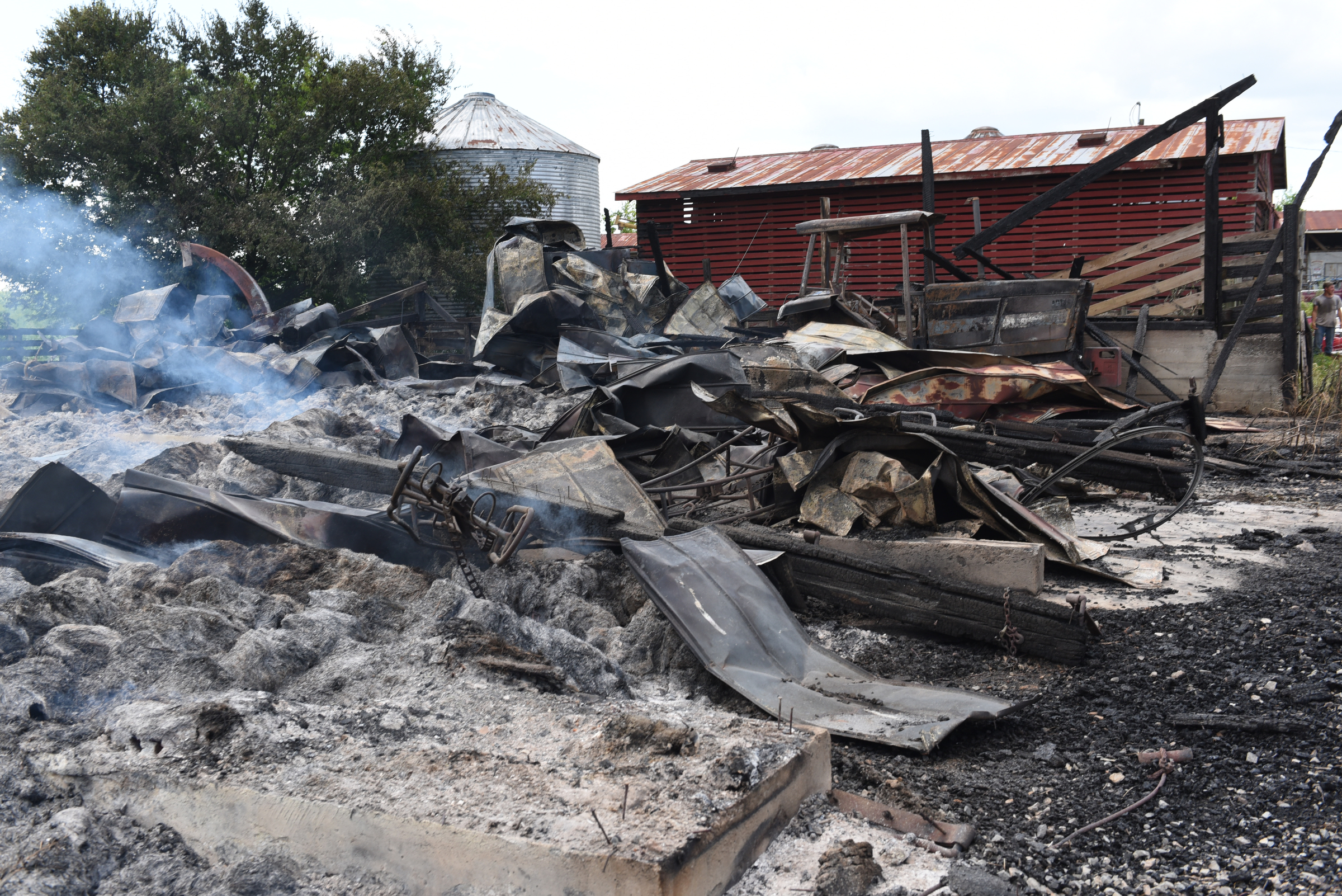 Smoke rises from the remains of an old barn on Jim Hagler's property on Wednesday, July 15, 2015, at Hagler Farms in Ten Mile, Tenn. The barn caught fire Tuesday night and burned to the ground after an apparent lightning strike during strong thunderstorms that moved through the area.