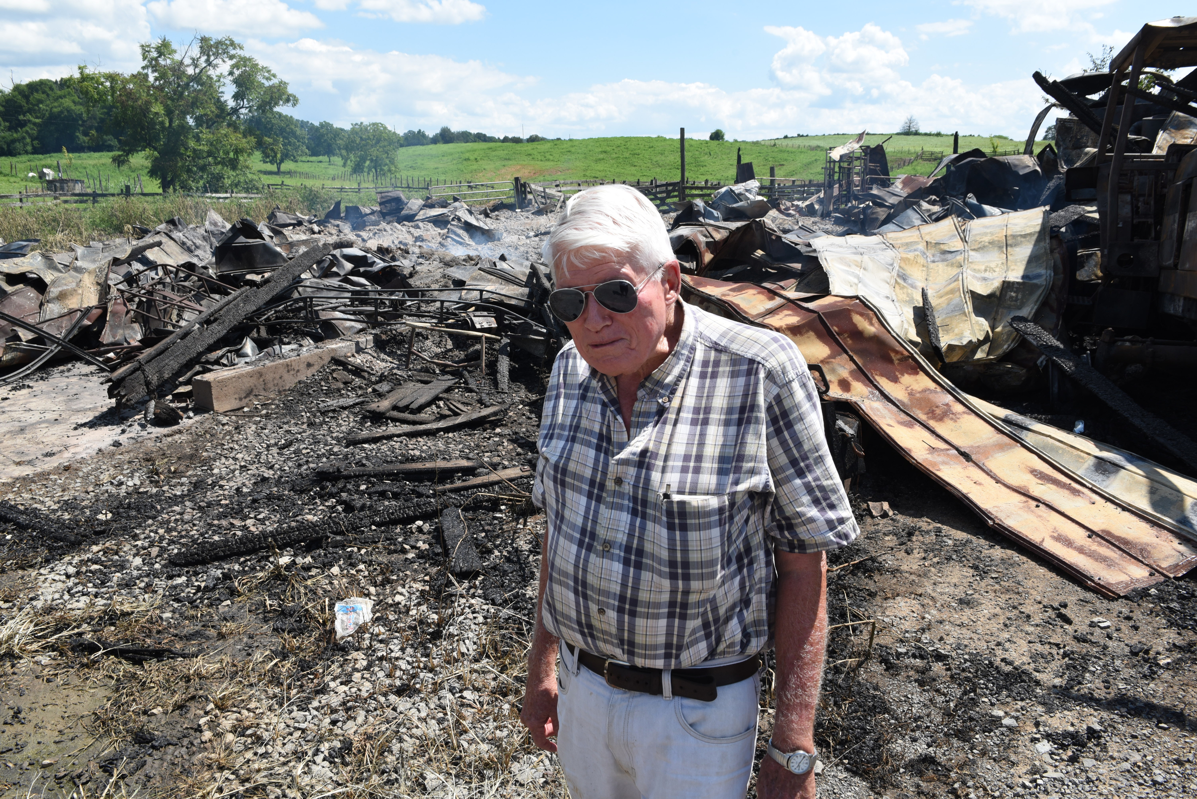 Jim Hagler stands in front of the remains of an old barn on his property on Wednesday, July 15, 2015, at Hagler Farms in Ten Mile, Tenn. The barn caught fire Tuesday night and burned to the ground after an apparent lightning strike during strong thunderstorms that moved through the area.