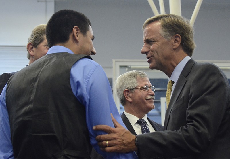 Tennessee Gov. Bill Haslam talks about his Tennessee Promise program with Bryan Hidalgo at Red Bank High School in 2014.