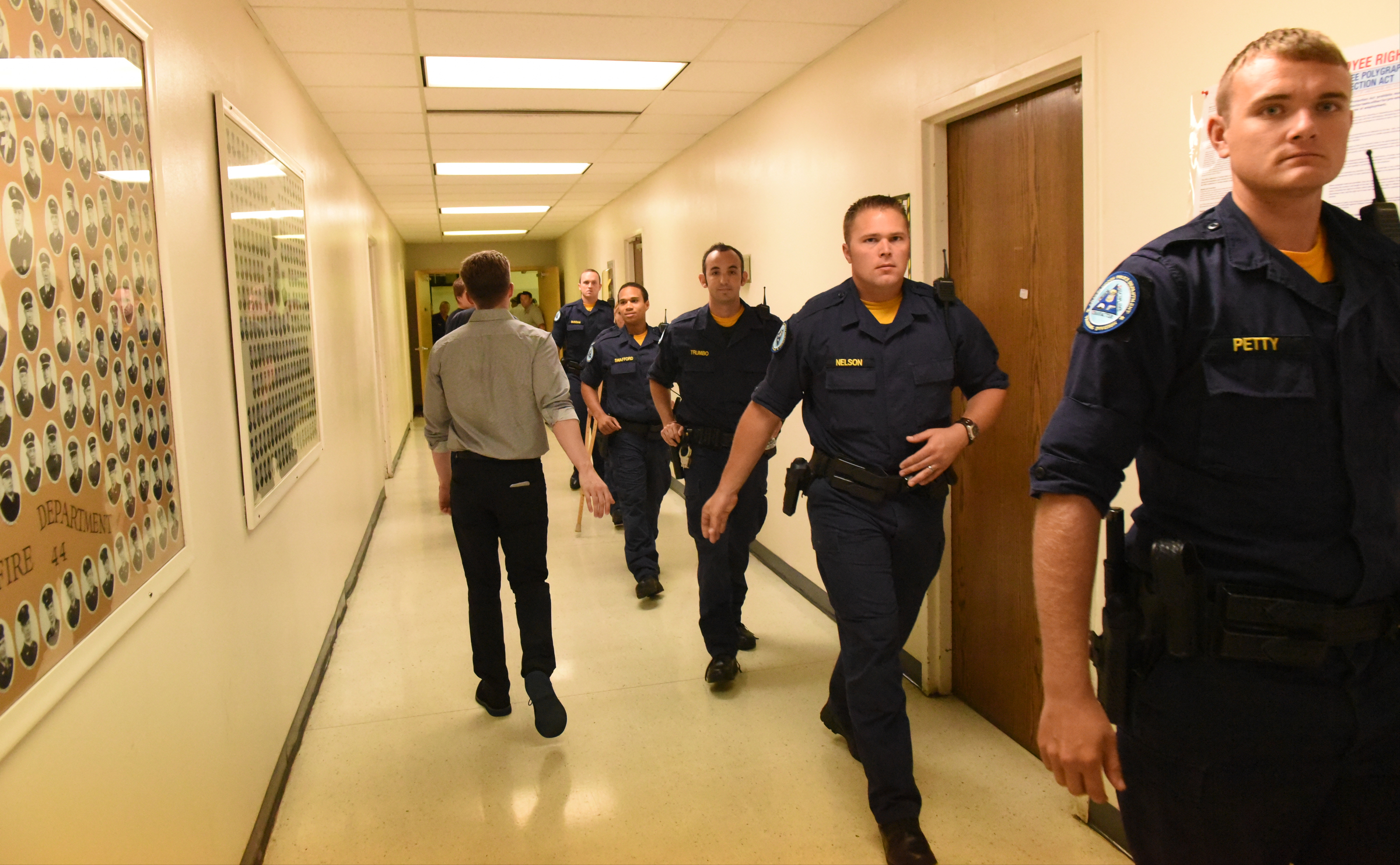 Chattanooga Police Cadets in training walk through a hallway at the Chattanooga Fire Training center after a domestic terror incident that killed four Marines at the nearby Naval Reserve facility on Amnicola Highway on Thursday, July 16, 2015, in Chattanooga, Tenn.