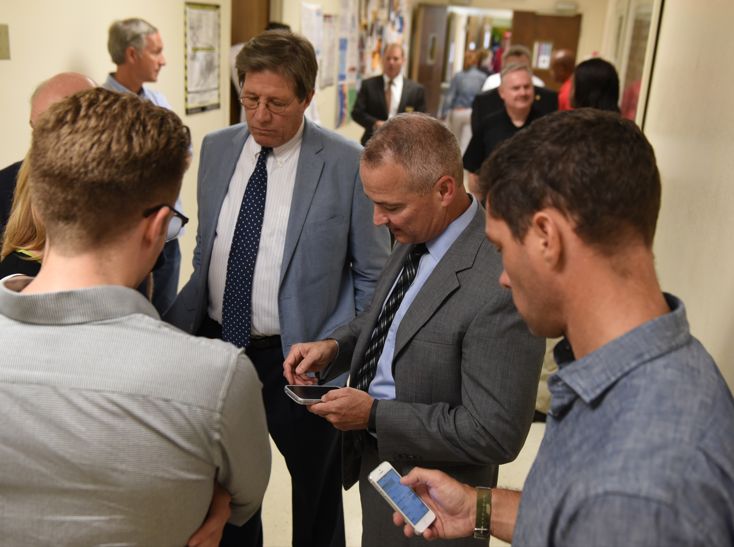 U. S. District Attorney General Bill Killian, left, and FBI Special Agent In Charge Ed Reinhold speak with others in a hallway after a news conference at the Chattanooga Fire Training center about a domestic terror incident that killed four Marines at the Naval Reserve facility on Amnicola Highway on Thursday, July 16, 2015, in Chattanooga, Tenn.