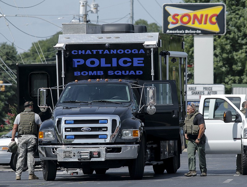 Law enforcement work around the Chattanooga Police's bomb squad truck.