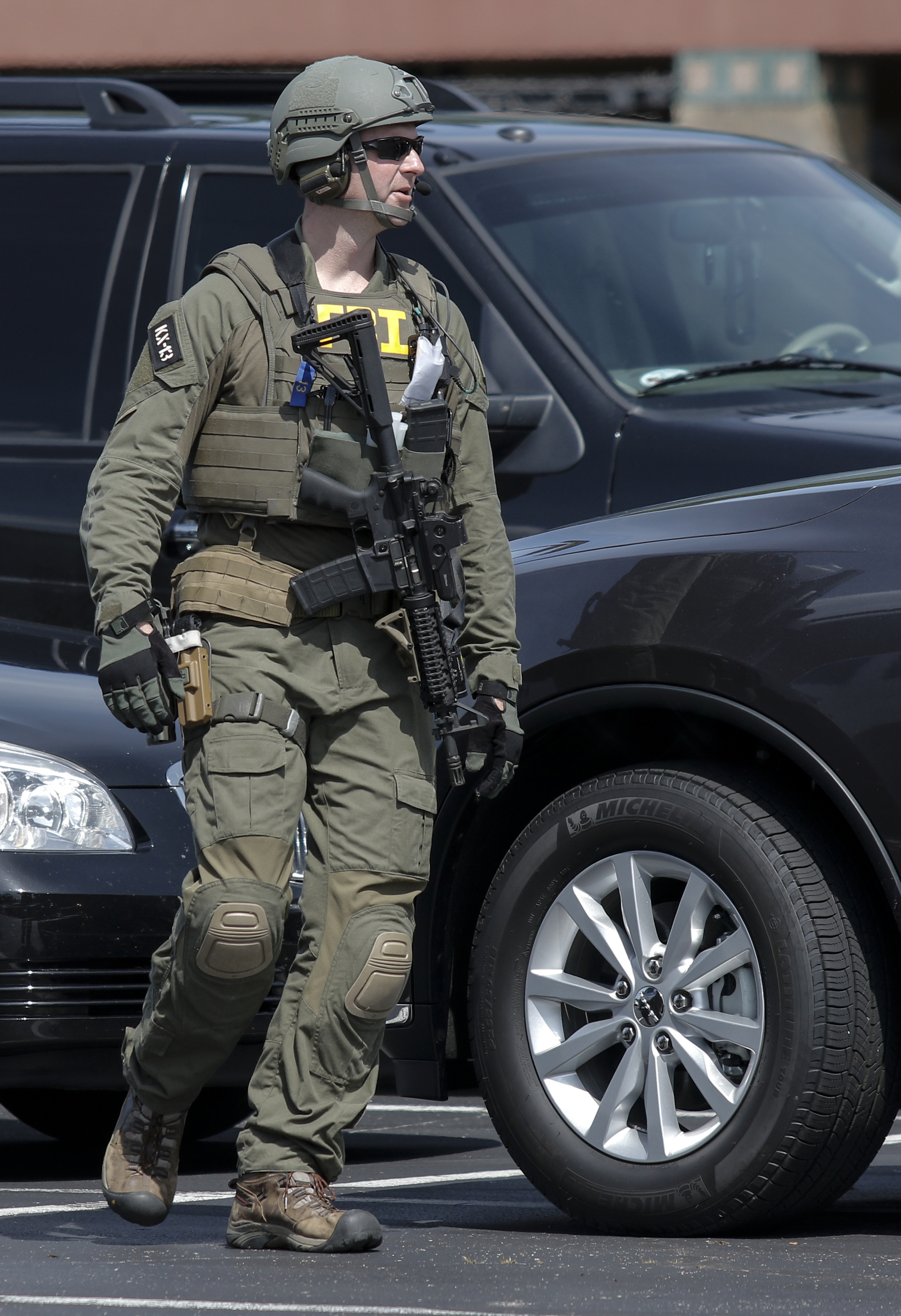 FBI agents prepare in a staging area on Hixson Pike before leaving to investigate the nearby home of gunman Mohammad Abdulazeez on Thursday, July 16, 2015, in Chattanooga, Tenn. Abdulazeez is the gunman in a shooting at both the Amnicola Highway Armed Forces Career Center and the Naval Operational Support Center on Amnicola Highway which left five dead, including the shooter, and a Chattanooga police officer wounded.
