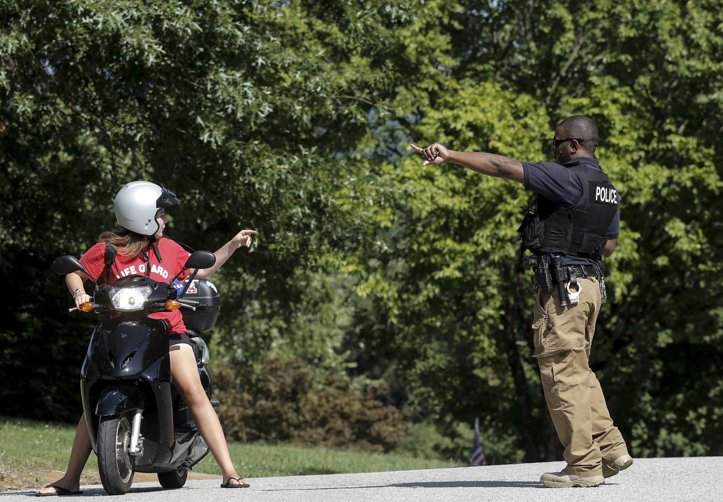 A Chattanooga Police Officer blocks access to the Colonial Shores neighborhood as police raid the home of gunman Mohammad Abdulazeez on Thursday, July 16, 2015, in Chattanooga, Tenn. Abdulazeez is the gunman in a shooting at both the Amnicola Highway Armed Forces Career Center and the Naval Operational Support Center on Amnicola Highway which left five dead, including the shooter, and a Chattanooga police officer wounded.