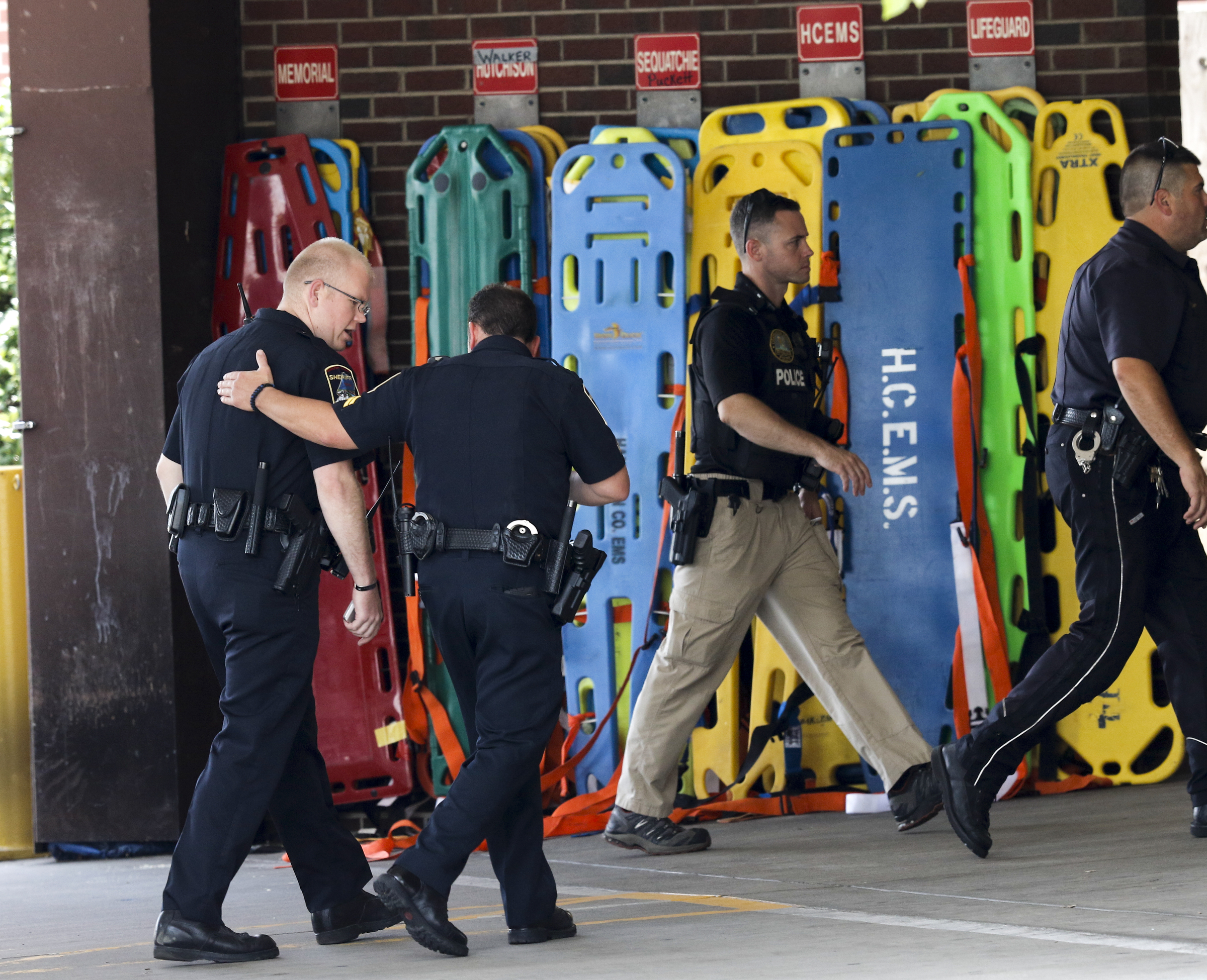 Officers enter the Erlanger Hospital ER after a shooting at both the Lee Highway Armed Forces Career Center and the Naval Operational Support Center on Amnicola Highway on Thursday, July 16, 2015, in Chattanooga, Tenn. The shooting left five dead, including the shooter, and a Chattanooga police officer wounded.
