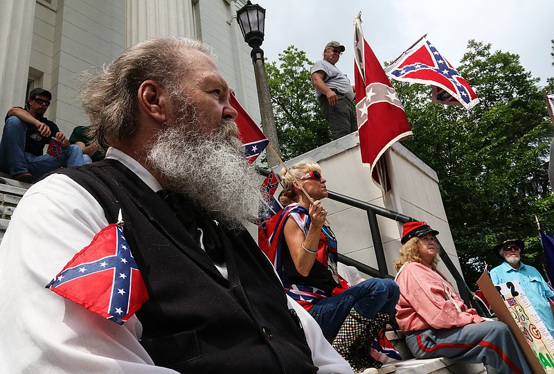 Henry Howard listens to speakers on the steps of the Alabama state capitol building on Saturday, June 27, 2015, in Montgomery, Ala.