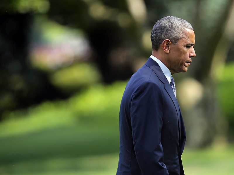 President Barack Obama walks across the South Lawn of the White House in Washington on Thursday, July 16, 2015, upon his arrival on Marine One helicopter after a short trip from Andrews Air Force Base, Md. Obama was heading towards the Oval Office and there he would be briefed by his counterterrorism and homeland security adviser and the FBI director on the recent shooting in Chattanooga. Obama promised a thorough and prompt investigation into an attack at two military sites that killed at least four Marines.
