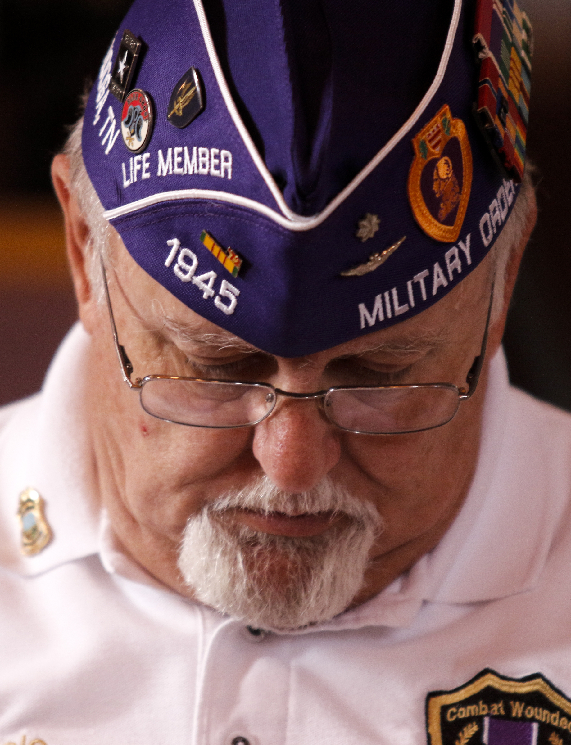 Retired Army Col. Chris Cole wears a Military Order of the Purple Heart hat at an interfaith vigil at Olivet Baptist Church held in remembrance of victims of the July, 16 shootings on Friday, July 17, 2015, in Chattanooga, Tenn. The vigil was held one day after gunman Mohammad Youssef Abdulazeez shot and killed four U.S. Marines and wounded two others and a Chattanooga police officer at the Naval Operational Support Center on Amnicola Highway shortly after firing into the Armed Forces Career Center on Lee Highway.