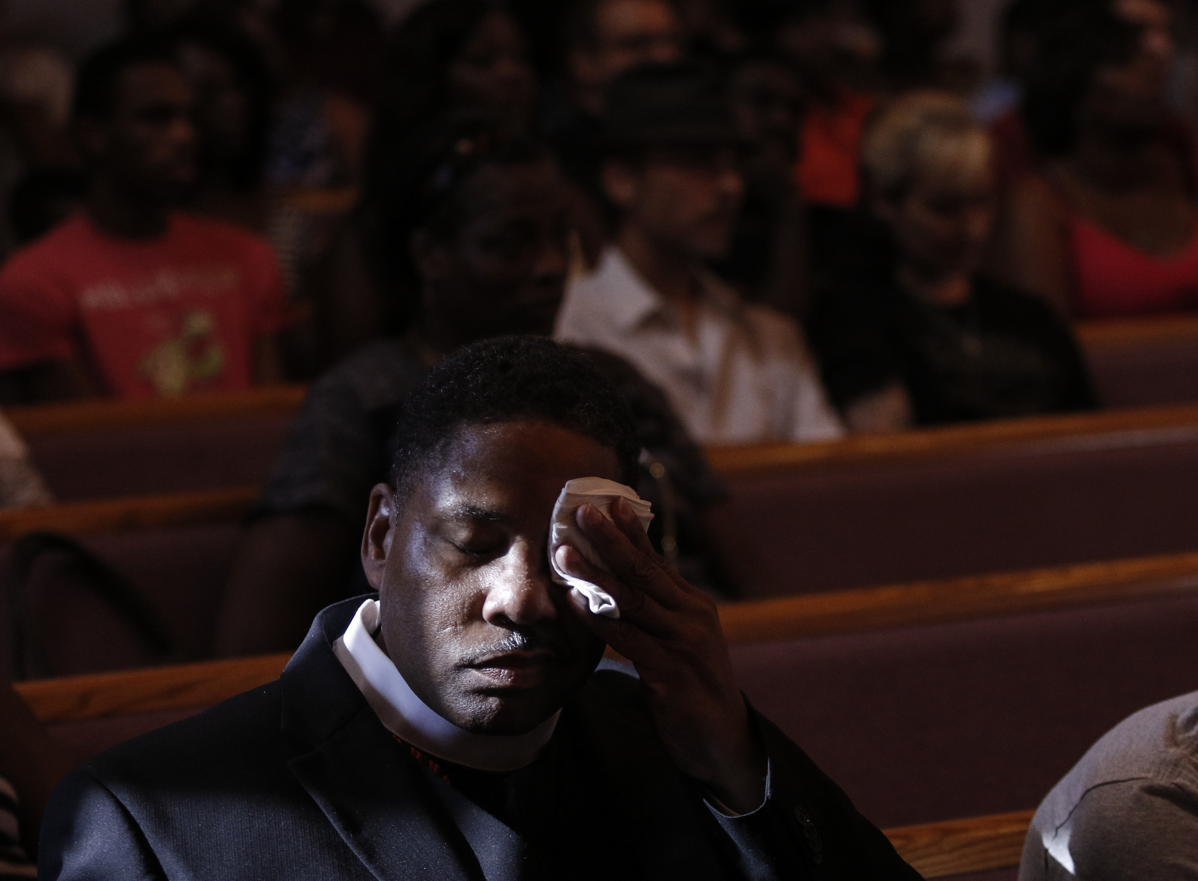 Dr. Wayne Faunteroy wipes his face during an interfaith vigil at Olivet Baptist Church held in remembrance of victims of the July, 16 shootings on Friday, July 17, 2015, in Chattanooga, Tenn. The vigil was held one day after gunman Mohammad Youssef Abdulazeez shot and killed four U.S. Marines and wounded two others and a Chattanooga police officer at the Naval Operational Support Center on Amnicola Highway shortly after firing into the Armed Forces Career Center on Lee Highway.
