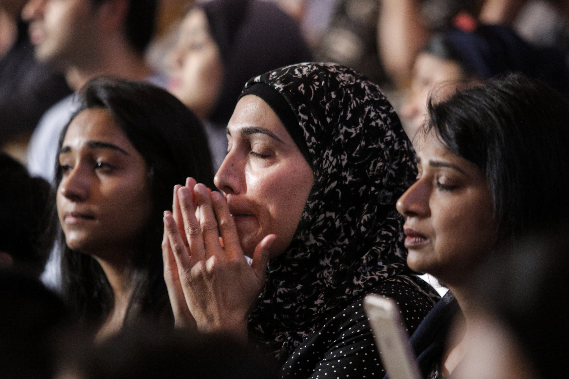 Uzma Munir, who came with others from the Islamic Society of Greater Chattanooga to offer their support, puts her hands to her face while listening during an interfaith vigil at Olivet Baptist Church held in remembrance of victims of the July, 16 shootings on Friday, July 17, 2015, in Chattanooga, Tenn. The vigil was held one day after gunman Mohammad Youssef Abdulazeez shot and killed four U.S. Marines and wounded two others and a Chattanooga police officer at the Naval Operational Support Center on Amnicola Highway shortly after firing into the Armed Forces Career Center on Lee Highway.