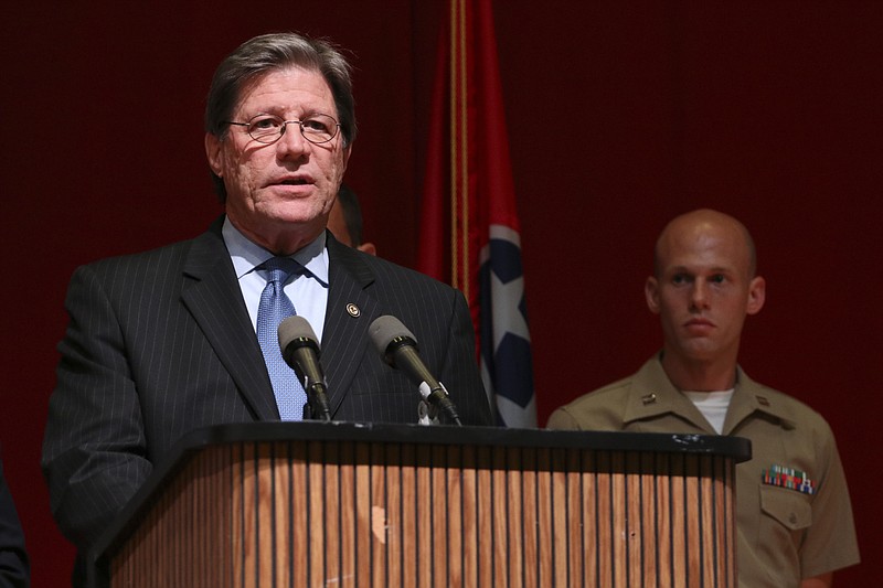 U.S. Attorney Bill Killian speaks to media as USMC Captain Ty Balzer listens from behind during a press conference at Tennessee Valley Authority's Missionary Ridge Auditorium on Friday, July 17, 2015 the day after a four Marines were shot and killed. The investigation is being treated as an act of terrorism. 