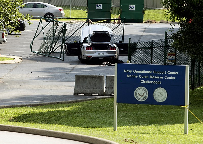 A car tangled in fencing sits parked just inside the gate at the Naval Operational Support Center and Marine Reserve Center where a gunman opened fire Thursday killing four U.S. Marines Friday, July 17, 2015, in Chattanooga