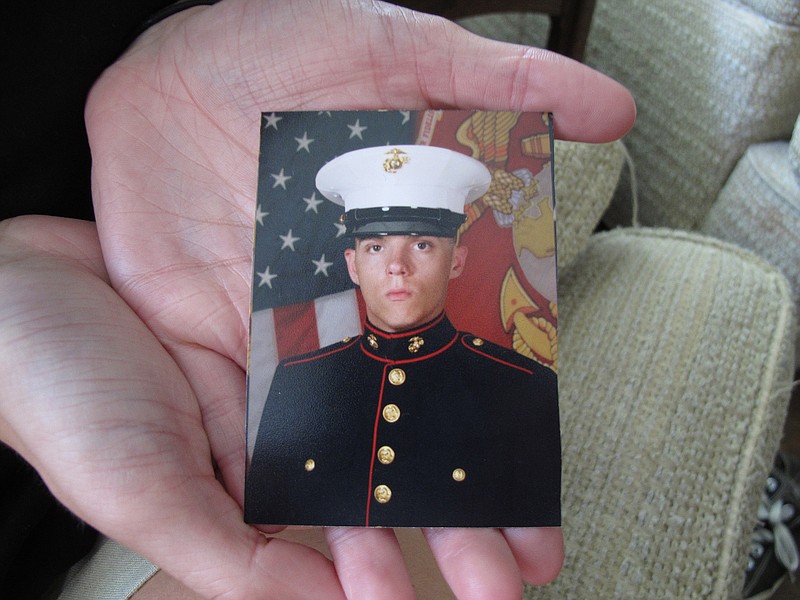 Caroline Dove holds a photo of Marine Corps Lance Cpl. Skip Wells, her boyfriend, in her hands July 17, 2015, at her home in Savannah, Ga. Wells was among four Marines killed July 16, 2015, in an attack at a military training facility in Chattanooga.