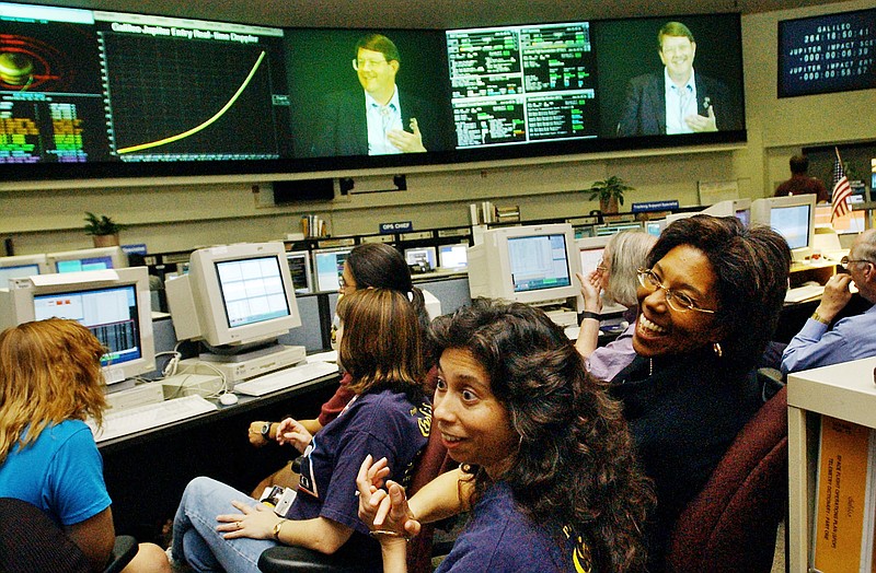 
              FILE - In this Sept. 21, 2003, file photo, Claudia Alexander, right, project manager for Galileo, waits in the mission control room in Pasadena, Calif., along with engineer Nagin Cox, center, and others for the spacecraft to take its final plunge into Jupiter. Alexander, a pioneering scientist who helped direct NASA's Galileo mission to Jupiter and the international Rosetta space exploration project, has died Saturday, July 11, 2015, after a long battle with breast cancer. She was 56. (AP Photo/Ric Francis, File)
            