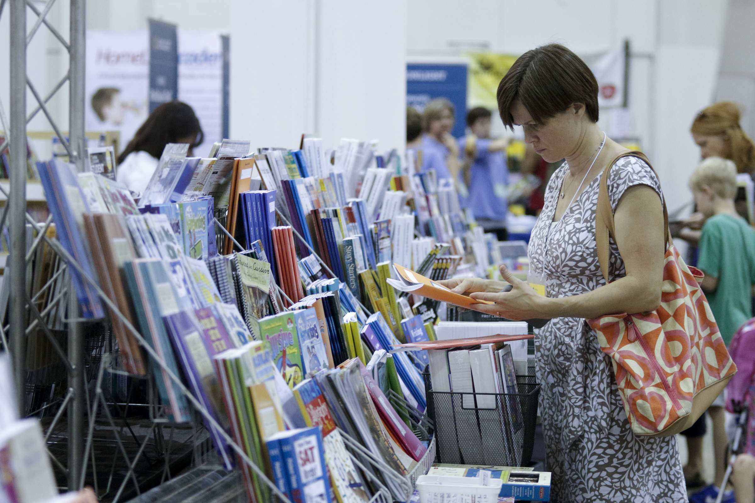 Laura Eichenberger browses a selection of books at the 32nd Annual Education Expo & Homeschool Curriculum Fair on Saturday, July 18, 2015, at Camp Jordan Arena in Chattanooga, Tenn.