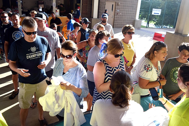 CFC fans line up to purchase "Nooga Strong" t-shirts at Saturday's match.  The shirts sold out and all the proceeds were to to to the 716 Freedom Fund to benefit the families of Thursday's tragedy.  Chattanooga FC hosted the Miami Fusion in soccer playoff action at  Finley Stadium Saturday night, July 18, 2015