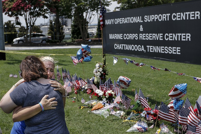 Sophia Ensley, right, and Barbie Branum hug in front of an Amnicola Highway memorial for victims of the July, 16 shootings on Saturday, July 18, 2015, in Chattanooga, Tenn. U.S. Navy Petty Officer Randall Smith died Saturday from wounds sustained when gunman Mohammad Youssef Abdulazeez shot and killed four U.S. Marines and wounded two others and a Chattanooga police officer at the Naval Operational Support Center on Amnicola Highway shortly after firing into the Armed Forces Career Center on Lee Highway.