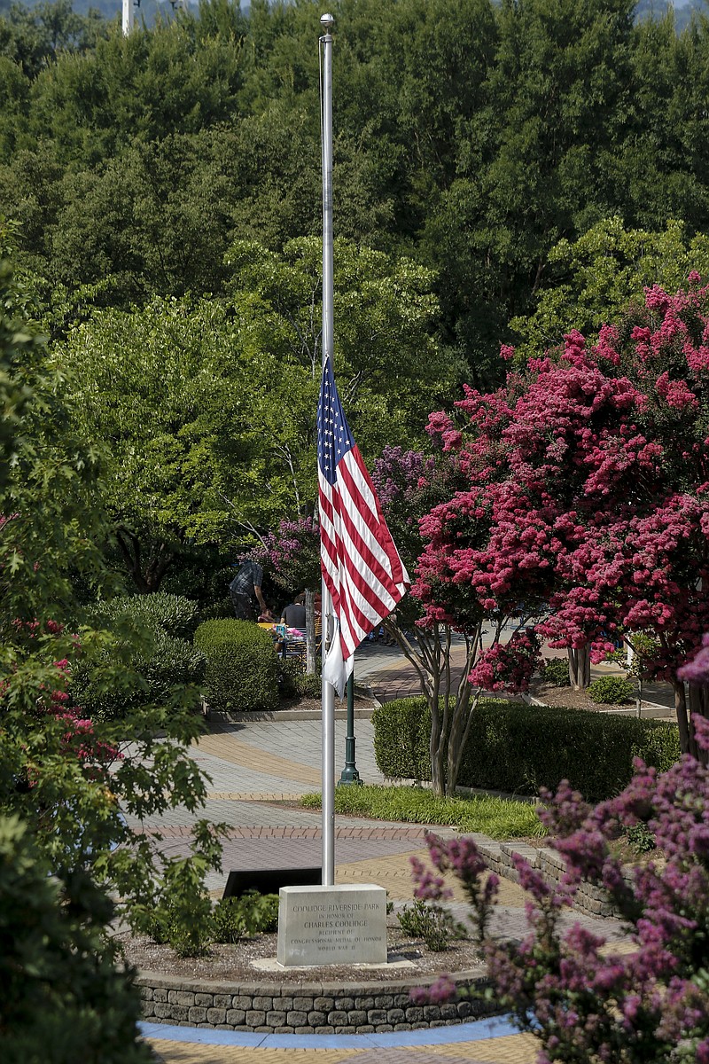 The American flag flies at half mast in Coolidge Park after Tennessee Gov. Bill Haslam ordered it lowered in honor of victims of the July, 16 shootings on Saturday, July 18, 2015, in Chattanooga, Tenn. U.S. Navy Petty Officer Randall Smith died Saturday from wounds sustained when gunman Mohammad Youssef Abdulazeez shot and killed four U.S. Marines and wounded two others and a Chattanooga police officer at the Naval Operational Support Center on Amnicola Highway shortly after firing into the Armed Forces Career Center on Lee Highway.