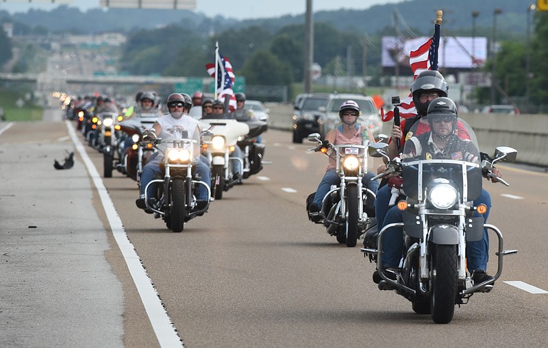 Motorcyclists travel on Highway 153 on Sunday, July 19, 2015, in Chattanooga, Tenn., as they ride from the Armed Forces Career Center on Lee Highway to the Navy Operational Support Center and Marine Corps Reserve Center on Amnicola Highway in the aftermath of a Thursday terrorist attack at those two facilities that killed four Marines and one member of the U. S. Navy.