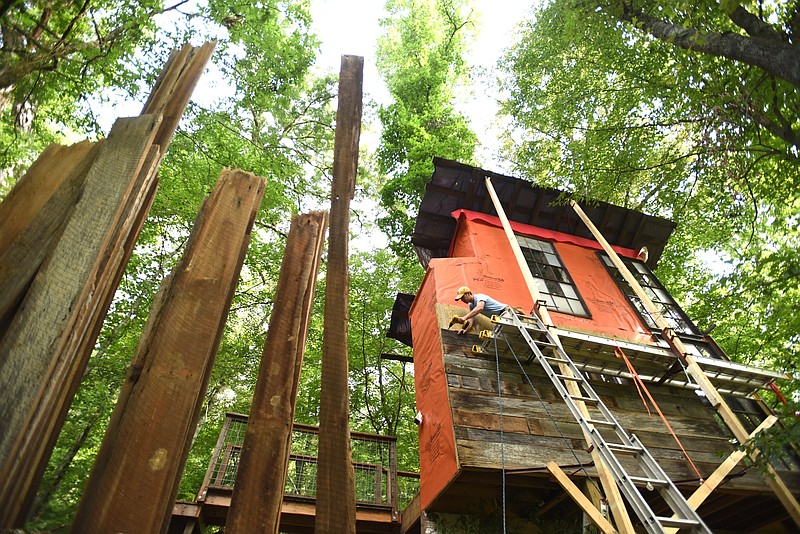 Andrew Alms works on the treehouse in Flintstone, Ga.