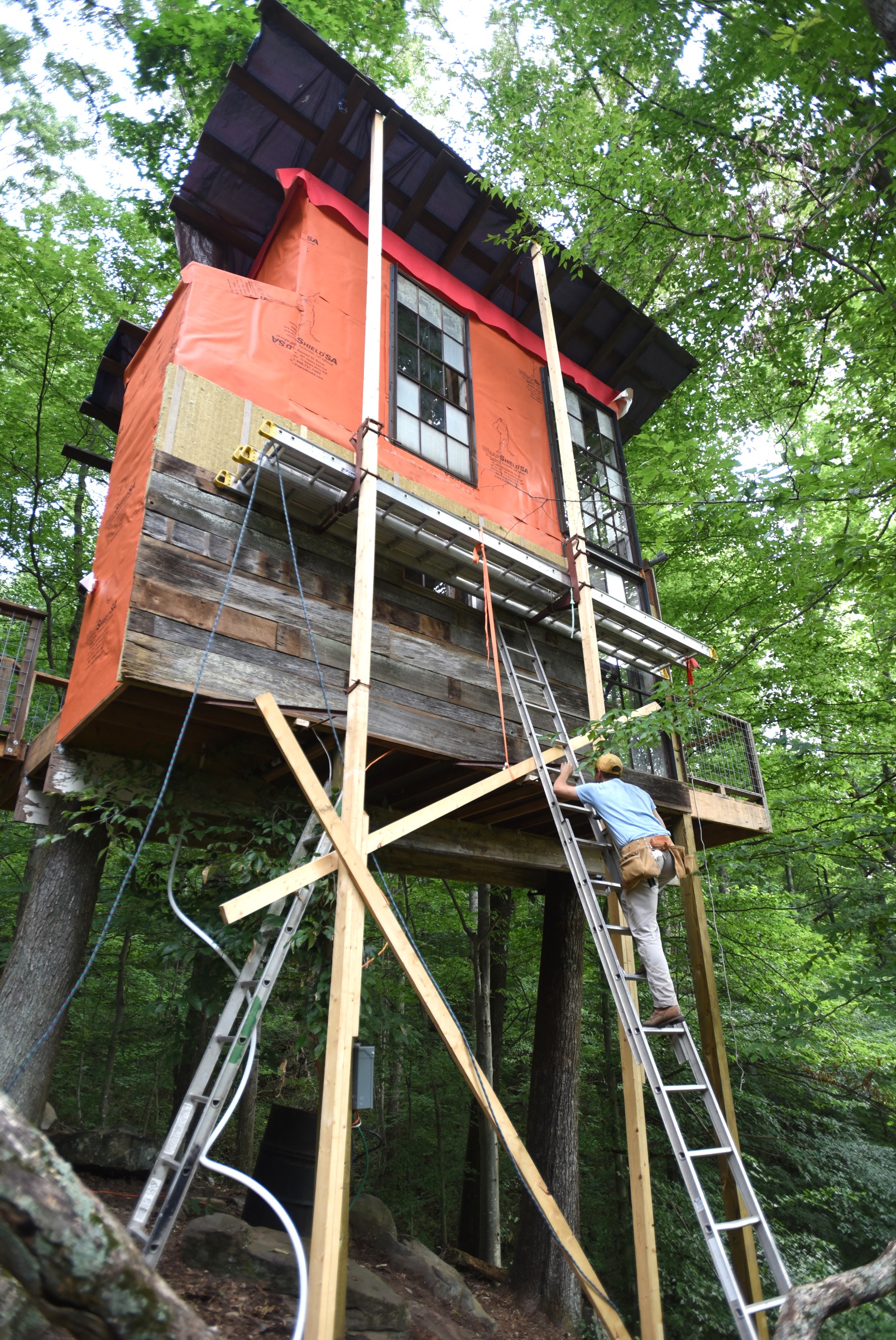 Andrew Alms works on the treehouse in Flintstone, Ga.
