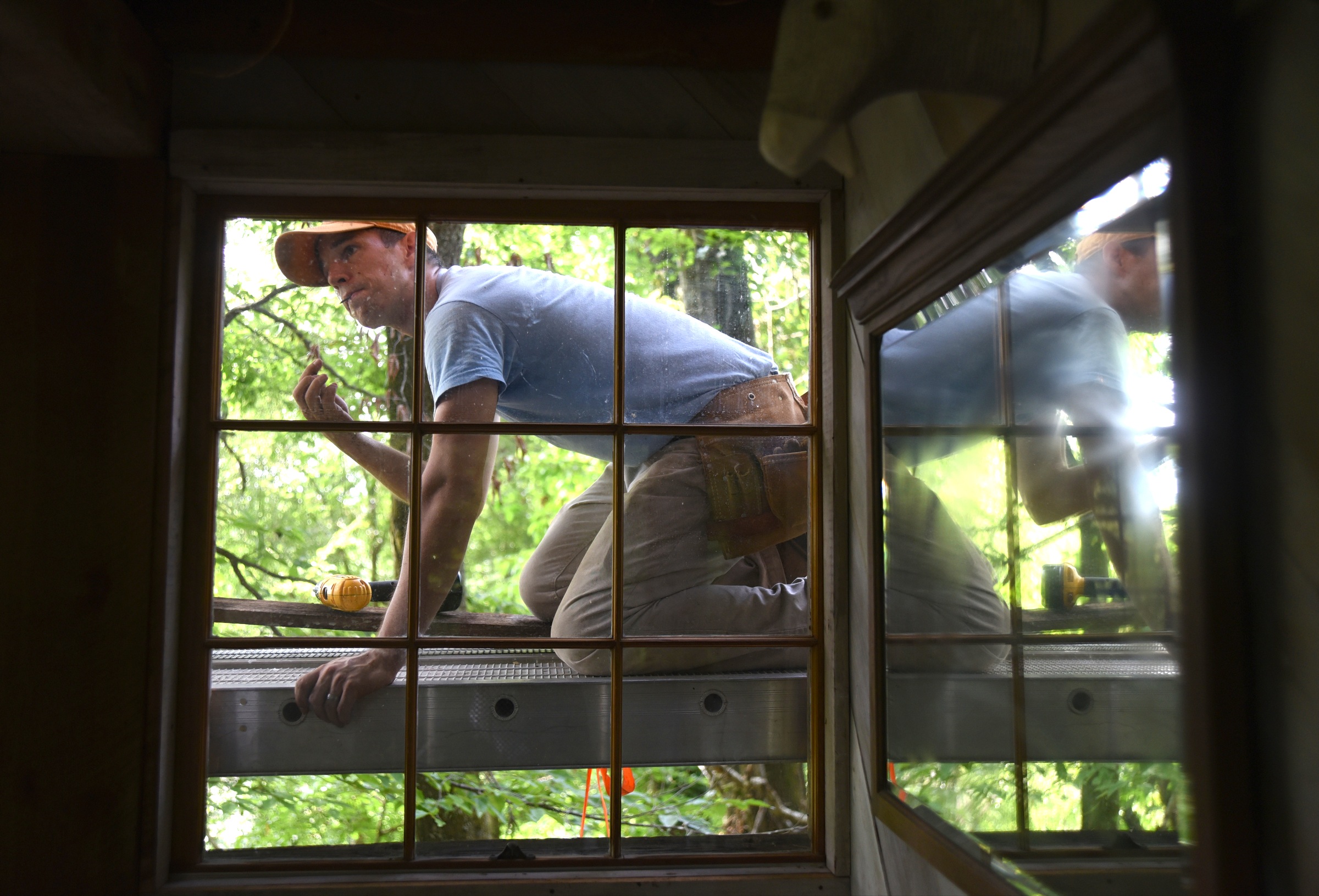 Andrew Alms works on the treehouse in Flintstone, Ga.
