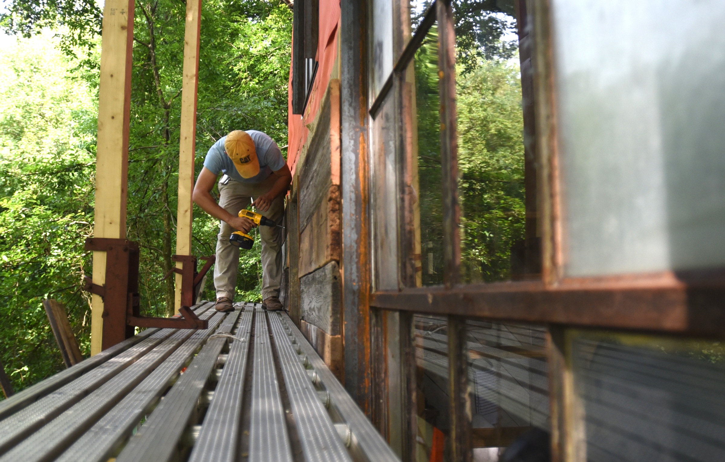 Andrew Alms works on the treehouse in Flintstone, Ga.