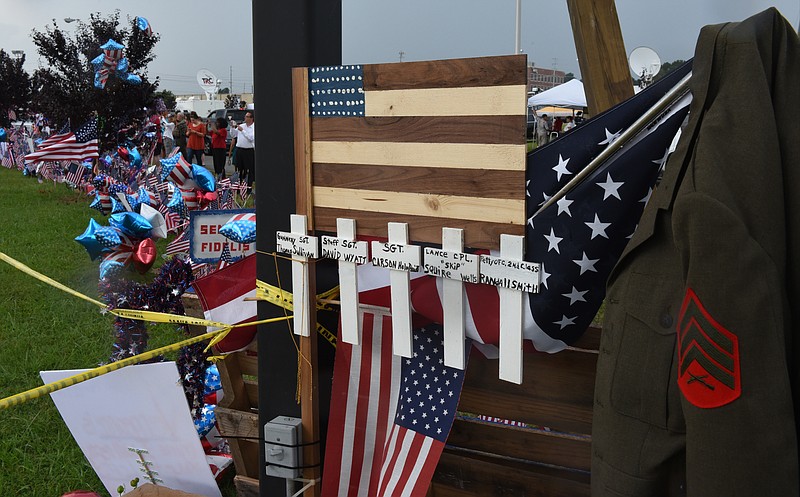 People continue to stream to the makeshift memorial at the Armed Forces Career Center on Lee Highway on Sunday, July 19, 2015, in Chattanooga, Tenn., in the aftermath of a Thursday terrorist attack that killed four Marines and one member of the U.S. Navy. 