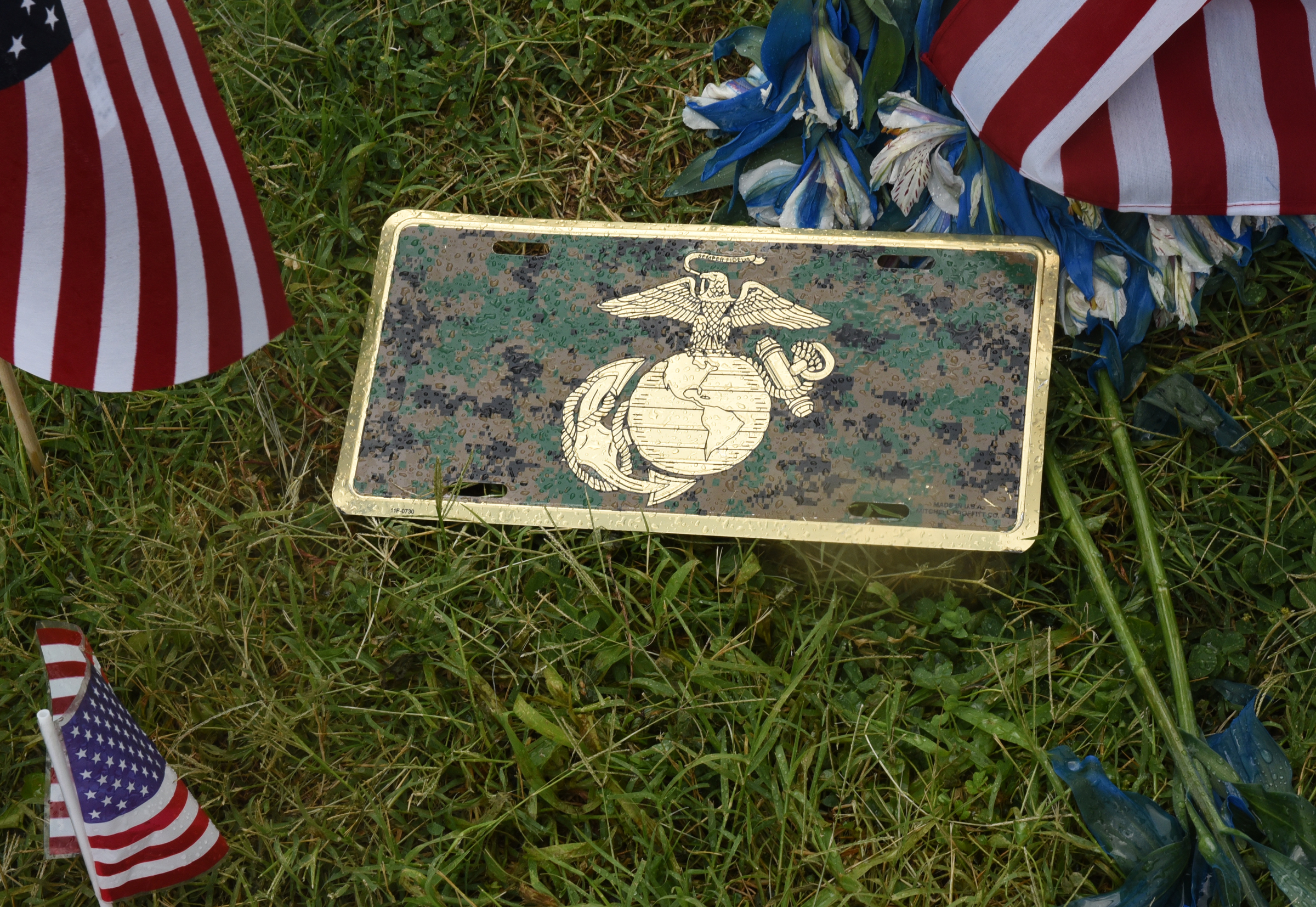 A Marine insignia is seen at the makeshift memorial at the Armed Forces Career Center on Lee Highway on Sunday, July 19, 2015, in Chattanooga, Tenn. A Thursday terrorist attack at two locations in Chattanooga killed four Marines and one member of the U.S. Navy.