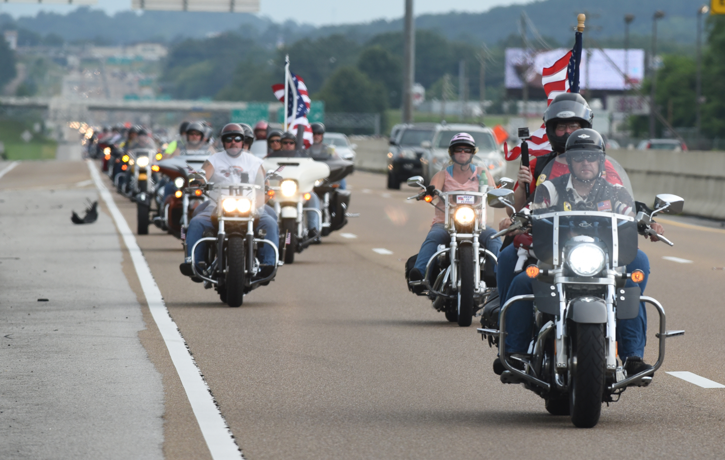 Motorcyclists travel on Highway 153 on Sunday, July 19, 2015, in Chattanooga, Tenn., as they ride from the Armed Forces Career Center on Lee Highway to the U.S. Naval and Marine Reserve Center on Amnicola Highway in the aftermath of a Thursday terrorist attack at those two facilities that killed four Marines and one member of the U.S. Navy.