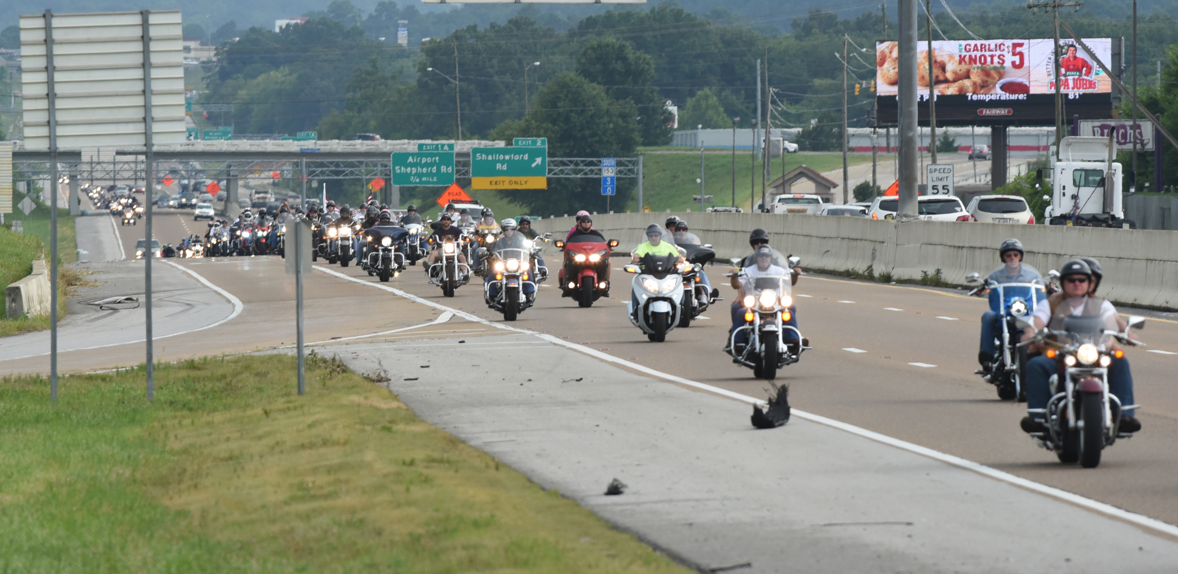 Motorcyclists travel on Highway 153 on Sunday, July 19, 2015, in Chattanooga, Tenn., as they ride from the Armed Forces Career Center on Lee Highway to the U.S. Naval and Marine Reserve Center on Amnicola Highway in the aftermath of a Thursday terrorist attack at those two facilities that killed four Marines and one member of the U.S. Navy.
